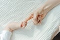Newborn children`s hand in mother hand. Mom and her Child. Happy Family concept Royalty Free Stock Photo