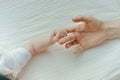 Newborn children`s hand in mother hand. Mom and her Child. Happy Family concept Royalty Free Stock Photo