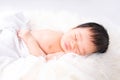 A newborn cute baby. Newborn child wearing white cotton fluffy. Infant baby girl sleeping in bed Royalty Free Stock Photo
