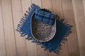 Newborn digital background - brown woven bowl with blue plaid pillow and blue layer on wooden background