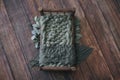 Newborn digital background - dark wooden bed with sage green knitted blanket on wooden floor