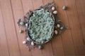 Newborn digital background - oval woven bowl with sage green faux fur, jute layer and easter eggs on wooden background. Newborn