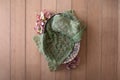 Newborn digital background - woven basket with orange and green hydrangea, green knitted layer on wooden background