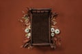 Newborn fall background - dark wooden bed with autumn leaves decor, white and cream pumpkins on orange and brown backdrop