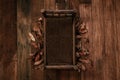 Newborn fall background - dark wooden bed with autumn leaves decor, white and cream pumpkins on orange and brown backdrop Royalty Free Stock Photo