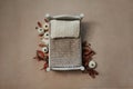 Newborn fall photography backdrop - white wooden bed on neutral beigi background with white and cream pumpkins and autumn foliage