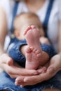 Parts of the body. The legs of the child in the hands of the mother. Royalty Free Stock Photo