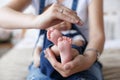 Parts of the body. The legs of the child in the hands of the mother. Royalty Free Stock Photo