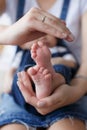 Parts of the body. The legs of the child in the hands of the mother. Royalty Free Stock Photo