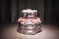 Newborn gift concept. Cake of diapers. Wrapped diapers as cake with flowers. Cake of wrapped clean diaper on table with baby doll
