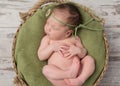 Newborn girl sleeping in a wicker basket Royalty Free Stock Photo