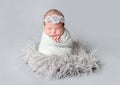 Newborn girl wrapped in blue wrap Royalty Free Stock Photo