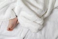 Newborn Ideas. Top Close-up View of a Four Week Old Baby Boy Feet Over Heap of White Towes