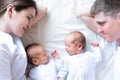 Newborn Identical twins on the bed, on a parents hands. Life style, emotions of kids. Infant Babies With Copy Space Royalty Free Stock Photo