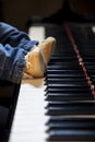 Newborn kid feet trying to play piano