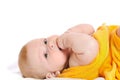 Newborn lies on back and holds finger in mouth Royalty Free Stock Photo