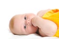 Newborn lies on back and holds finger in mouth Royalty Free Stock Photo