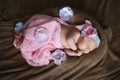 Newborn little girl who sleeps soap, soft pink scarf covered with lace satin flower, gently folded under the handle small head Royalty Free Stock Photo