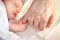 Baby sleeping holding the finger of his father. Royalty Free Stock Photo