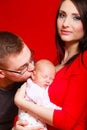 Newborn on mother chest father kissing baby Royalty Free Stock Photo