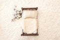 Newborn photography background - rustic wooden bed with white chunky blanket, knitted pillow on white fluffly backgdrop