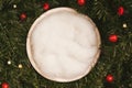 Newborn photography background - white bowl on pine tree background, with snow, pinecones and ornaments. Christmas newborn