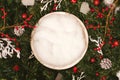 Newborn photography background - white bowl on pine tree background, with snow, pinecones and ornaments. Christmas newborn