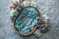 Newborn photography background - woven basket with teal faux fur and blue and pink peonies