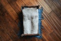 Newborn rustic background - wooden bed with grey blanket, blue throw on dark wooden backdrop