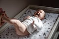 A newborn is screaming on a changing table. Stomach pain, childhood cramps. Crying newborn baby. The first year of life Royalty Free Stock Photo