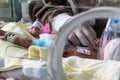 Newborn sick baby in an incubator