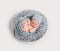 Newborn sleeping curled in his wrap, topview