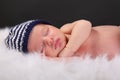Newborn sleeping with hat fuzzy blanket Royalty Free Stock Photo