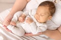 A newborn sleeps in his mother`s arms, close-up, quiet sleep of Royalty Free Stock Photo