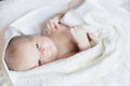 Newborn tiny baby lying on the bed side view Royalty Free Stock Photo