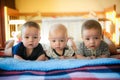 Newborn triplets are lying in the bed Royalty Free Stock Photo