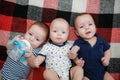 Newborn triplets are lying in the bed Royalty Free Stock Photo