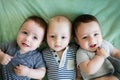 Newborn triplets are lying in the bed Royalty Free Stock Photo