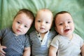 Newborn triplets are lying in the bed Royalty Free Stock Photo