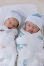 Newborn twins sleeping. Newborn Babies Twins Sleep in Bed. Lovely sleep of the newborns babies on the bed. Royalty Free Stock Photo