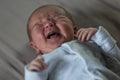 Newborn 1 week old baby is crying. Love and tenderness. Close-up