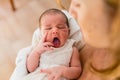 Newborn yawning in her mother`s arms