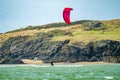 Newborough , Wales - April 26 2018 : Kite flyer surfing at Newborough beach - Wales - UK