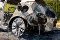 Newburn UK: A stolen car which has been burnt out and dumped in a field. Burnt fuel tank