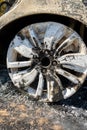 Newburn UK: A stolen car which has been burnt out and dumped in a field. Burnt alloy wheels