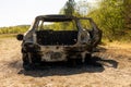 Newburn UK: A stolen car which has been burnt out and dumped in a field. Burnt fuel tank