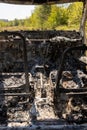 Newburn UK: April 2022: A stolen car interior which has been burnt out and dumped in a field