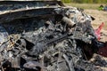 Newburn UK: April 2022: A stolen car which has been burnt out and dumped in a field