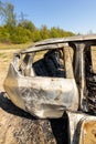 Newburn UK: April 2022: A stolen car which has been burnt out and dumped in a field