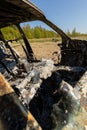 Newburn UK: April 2022: A stolen car which has been burnt out and dumped in a field